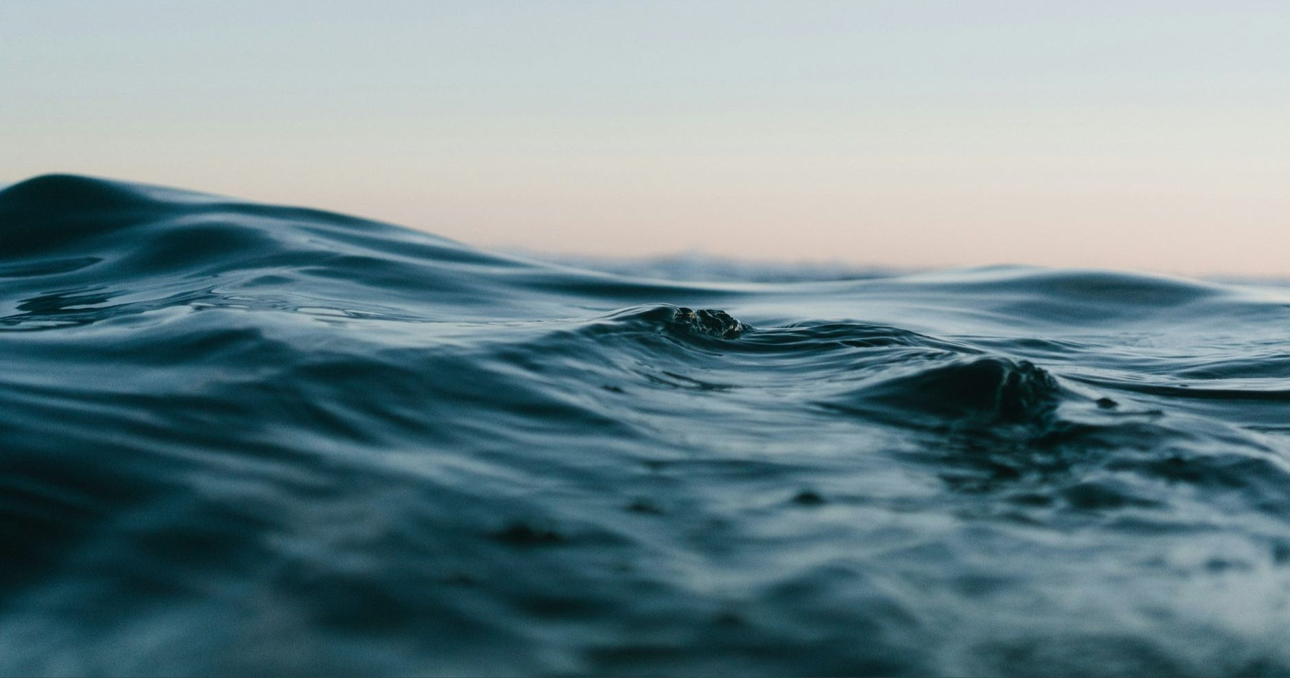 Waves on a body of water with a gradient sky